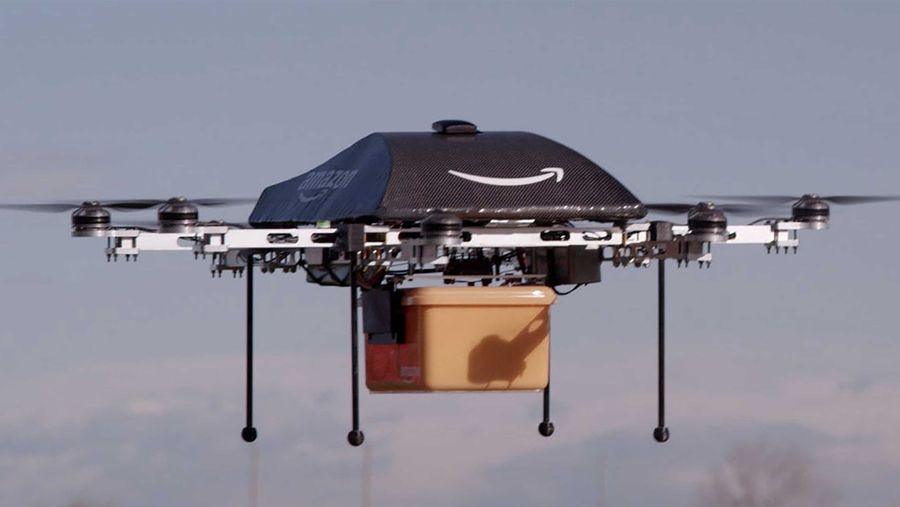 Amazon Drones deliver package while airborne