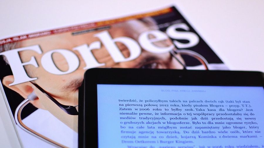 Forbes magazine with a tablet - Xplornet best employer in Canada
