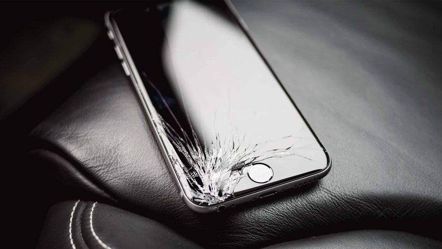 broken iphone on leather car seat - asurion