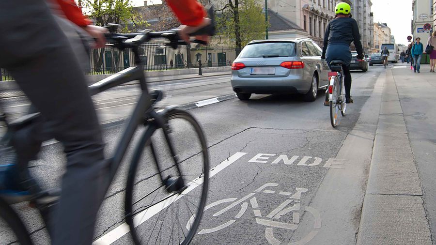 Bicycles on bike path near car