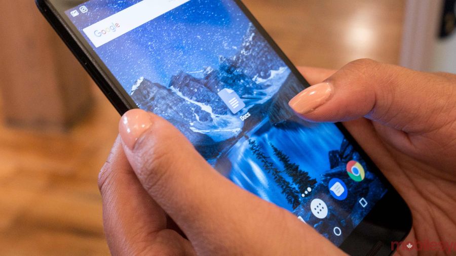 An image showing a hand holding a Nexus 5X with the Google Docs app on-screen