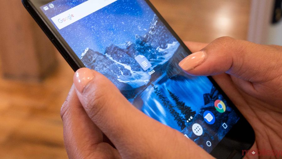 An image showing a hand holding a Nexus 5X with the Google Docs app on-screen
