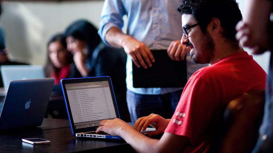 Coders typing on laptop