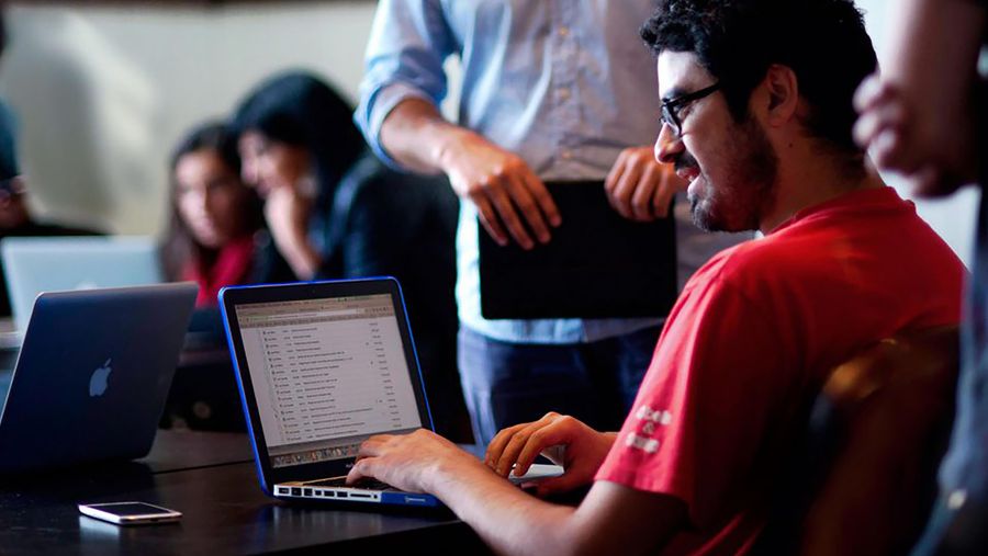 Coders typing on laptop