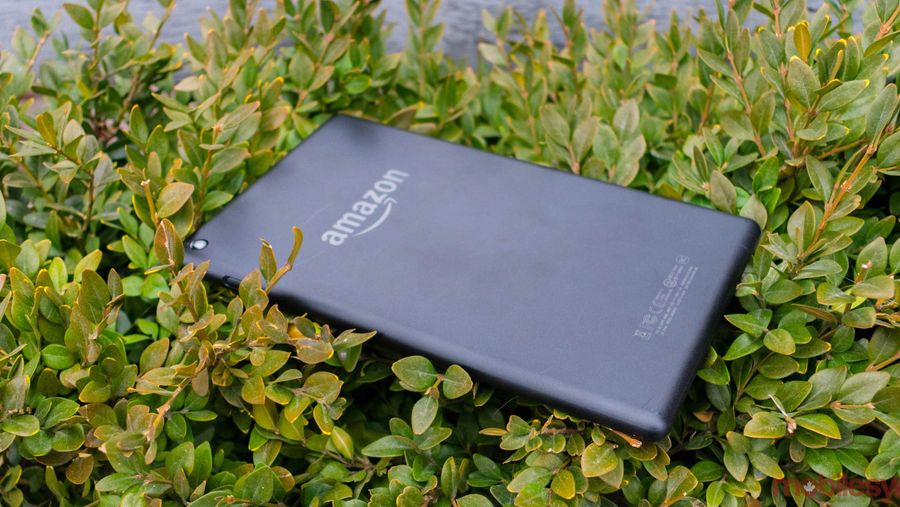 An Amazon tablet placed on a patch of grass.