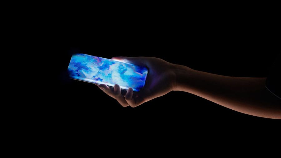 Someone holding the xioami phone with a black background