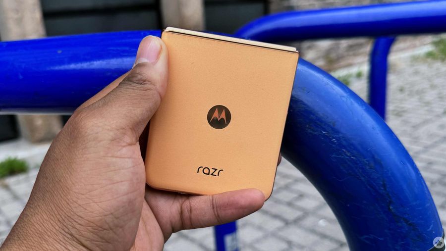 a gold motorola razr plus 2024 closed in someone's hand