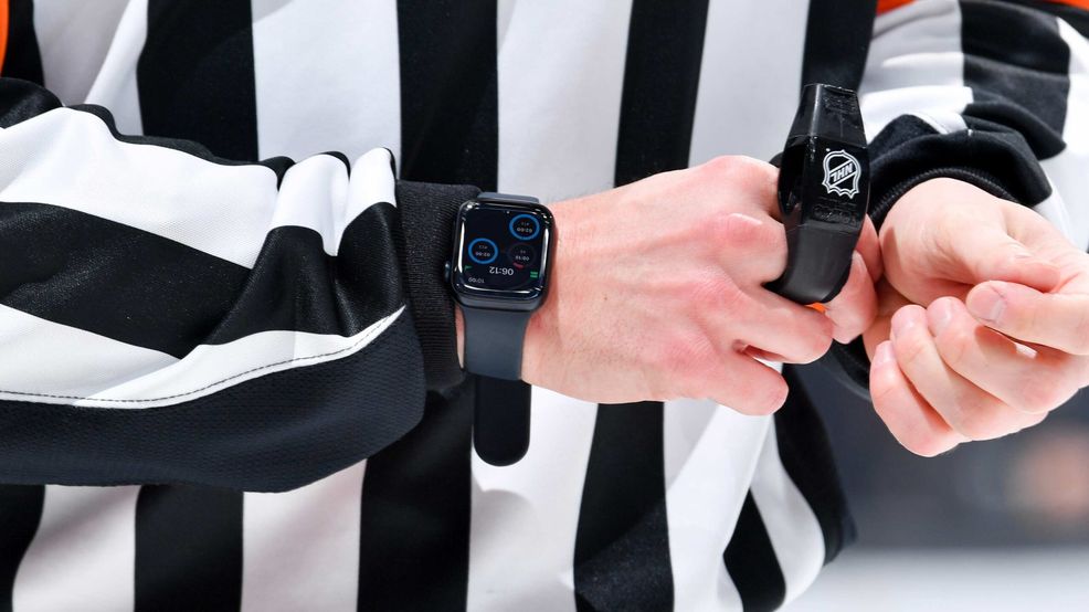 An NHL referee wearing an Apple Watch