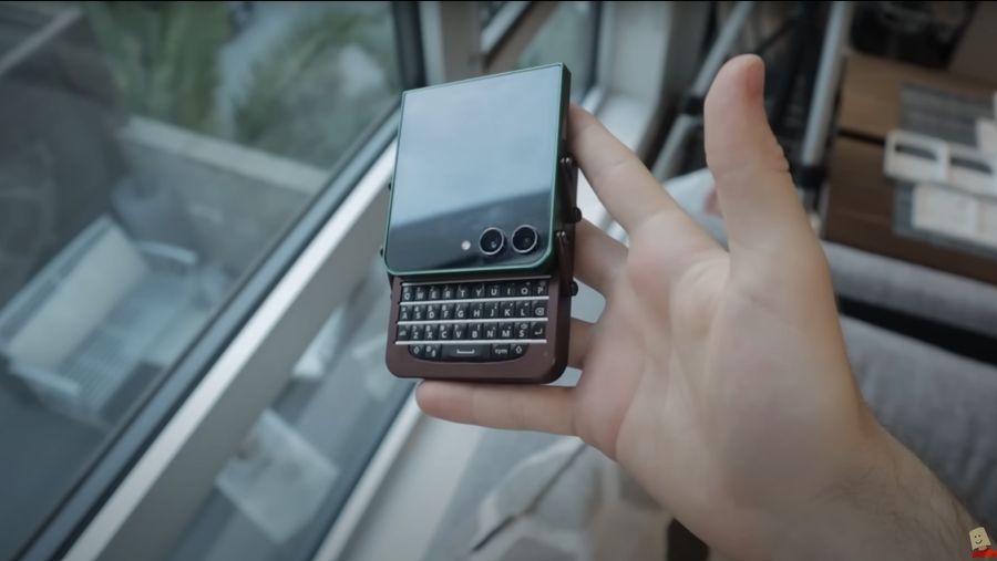 Marcin Plaza holding his modified Galaxy Z Flip 5 with the keyboard showing.