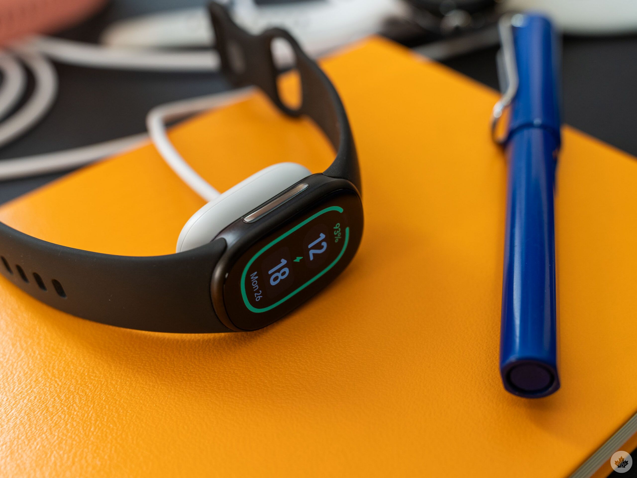 Fitbit Edge on a charger.